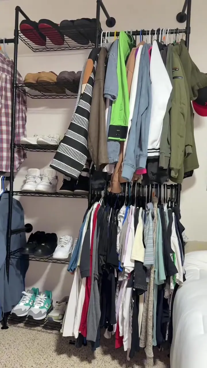 Organized closet system with hanging clothes and shoe shelves